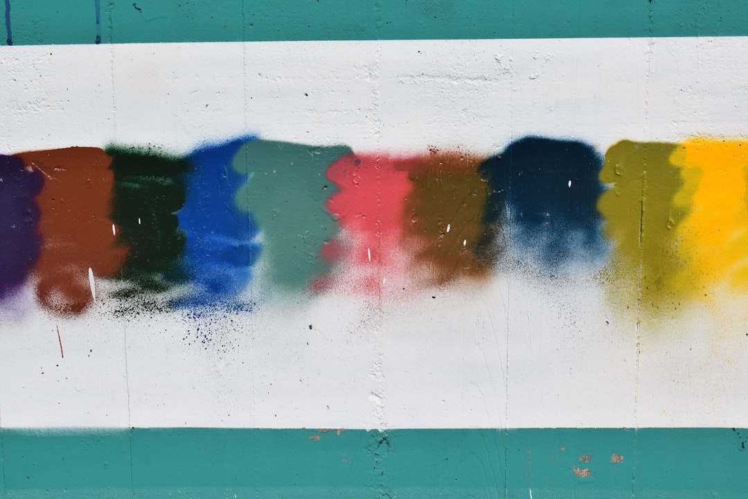 a-group-of-different-colors-of-paint-on-a-wall-a0qlelubmde